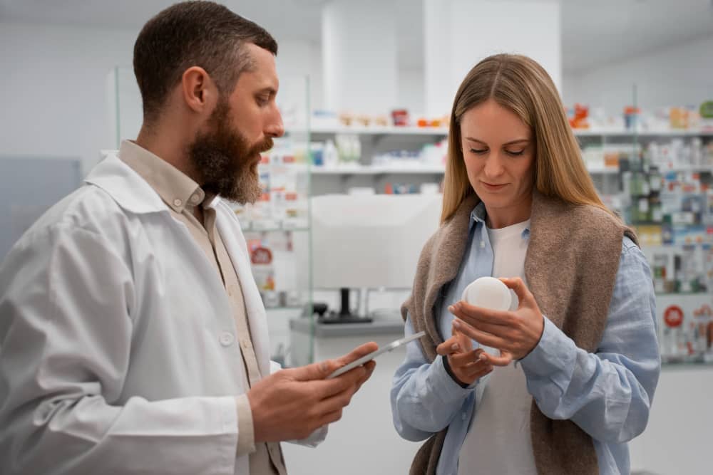 Pharmacist assisting a client at Maxwell Pharmacy in Frankston TX